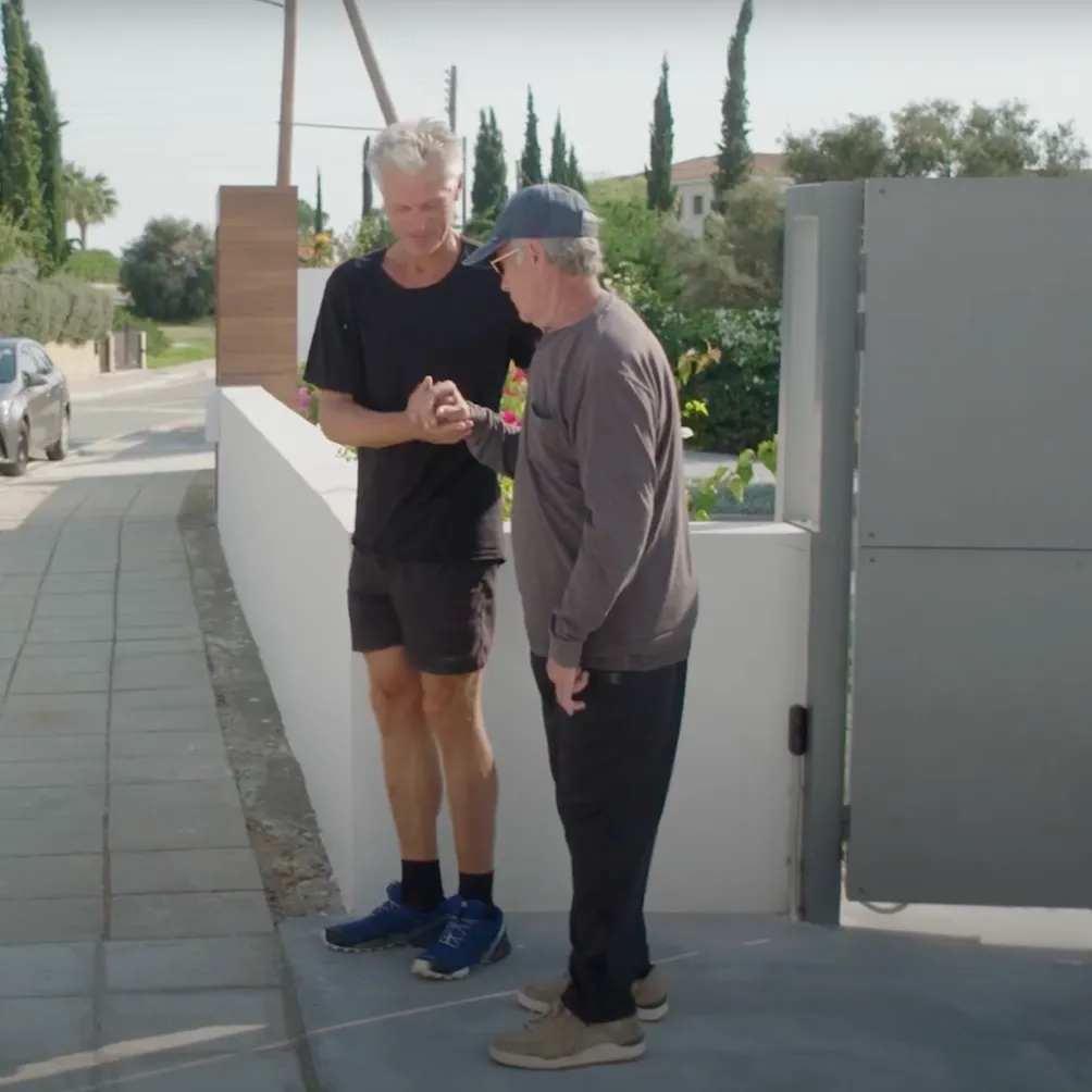 Photo of our Trainer Wim helping a stroke survivor learning how to walk
